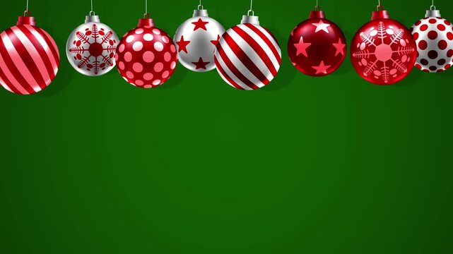 Festive Christmas motion background of red and white baubles with stripes, stars, snowflakes and polka dots on a green backdrop for promotional or advertisement.