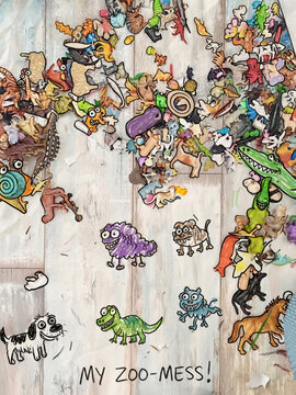 A digital illustration in a hand-drawn crayon and colored pencil style featuring a chaotic collection of quirky, funny animals and creatures scattered across a wooden-textured surface, with the handwr