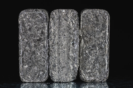 Compressed blocks of aluminum scrap formed from processed non ferrous metal waste, irregular structure of compacted aluminum fragments. Secondary raw material for metallurgical and metal processing in