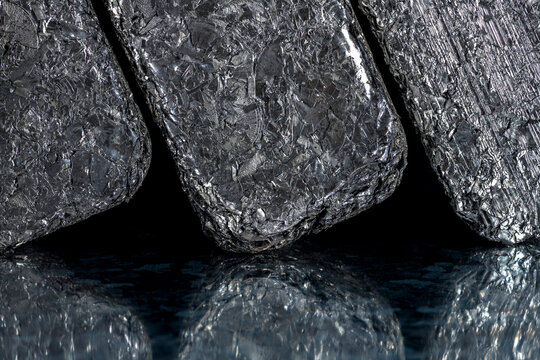 Compressed blocks of aluminum scrap formed from processed non ferrous metal waste, irregular structure of compacted aluminum fragments. Secondary raw material for metallurgical and metal processing in