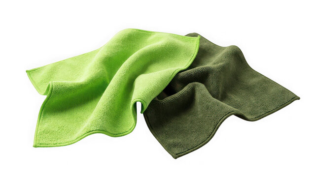 Two folded microfiber cleaning cloths in light and dark green isolated on transparent background