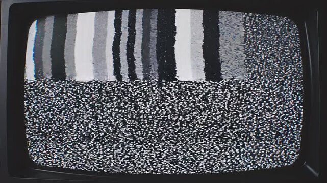 Retro television screens displaying static and broadcast signal interference during a nighttime broadcast