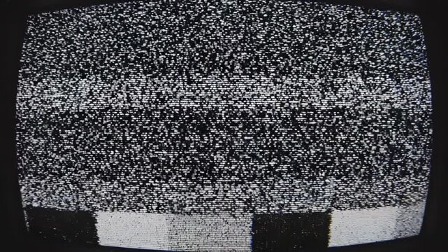 Retro television screens displaying static and color bars during a broadcast interruption in a dark studio