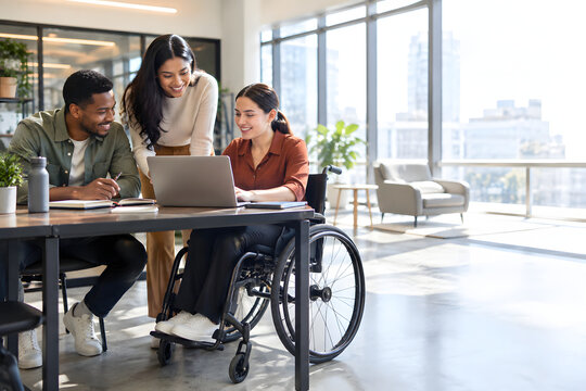 Inclusive workplace team collaborating around a laptop