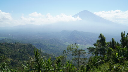 Fototapeta premium Beautiful landscape view of Mount Agung volcano with tropical palm trees in Bali
