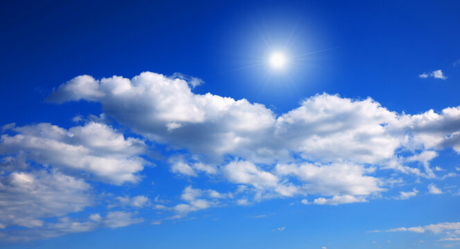 blue sky with clouds and sun shines