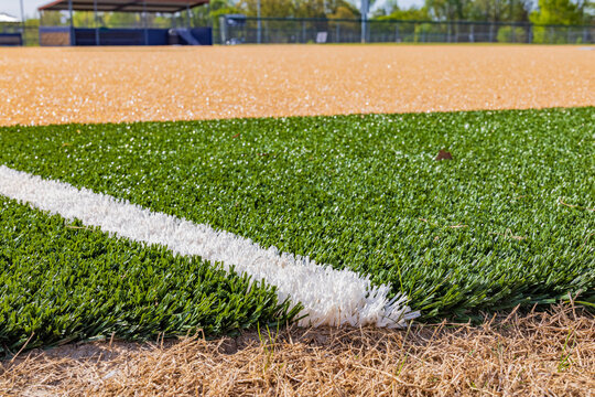 A white line marks the boundary on a green artificial turf field.