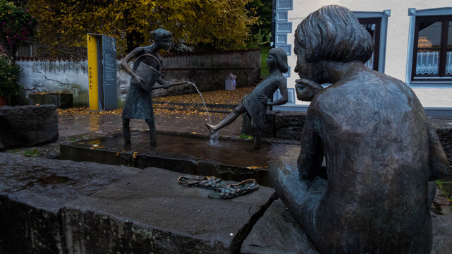 Bronze fountain statues depicting children playing with water in F&uuml;ssen old town, Bavaria, Germany