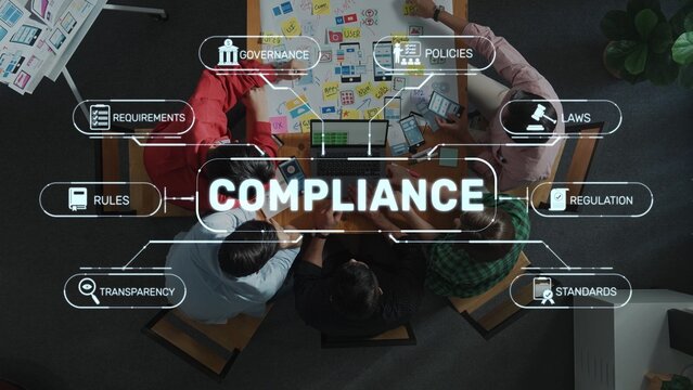 Aerial view of a team working on compliance concepts in a modern office setting. Visual representations of governance, policies, and regulations highlight collaborative efforts. Raster
