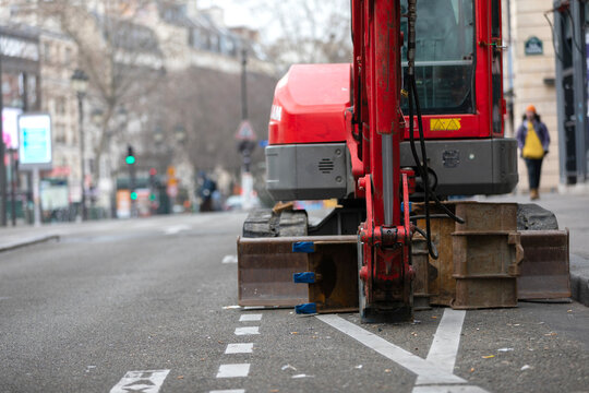Mini Excavator with Hydraulic Breaker on Urban Street