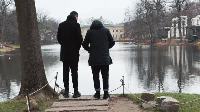 Two Men Observe Palace on the Isle in Warsaw's Royal Baths Park