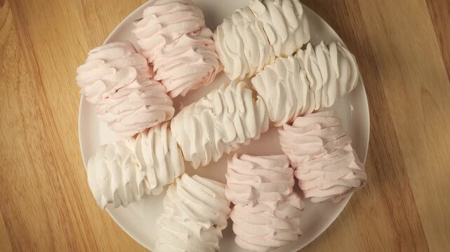 Rotating plate of pink and white zefir marshmallows