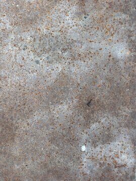 Rusted metal texture surface background, rusty iron sheet backdrop with small corrosion spots, grunge industrial pattern