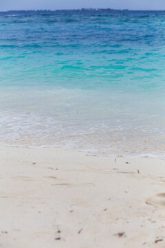 White sand beach with transparent water shore in Maldives