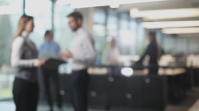 Blurred office with people working