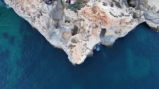 Aerial top-down view revealing algar seco cliffs and restaurant