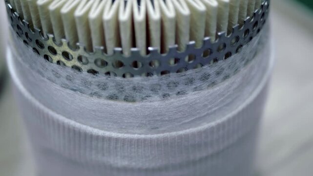 A cross-section of a filter to understand the internal structure and purpose of different materials. Closeup. Shot in motion. Follow focus
