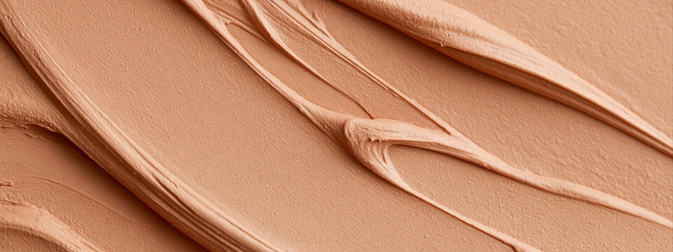 Thick liquid foundation swatch texture. Warm beige cosmetic concealer and cream smear