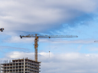 Tower crane at a construction site against the sky © Dmitrii Potashkin