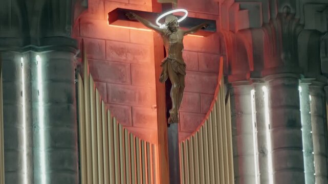 Jesus Christ with a glowing halo above his head, crucified on a wooden cross inside the Christ the King Cathedral (also known as the Stone Church or Nha tho Nui) in Nha Trang, Vietnam