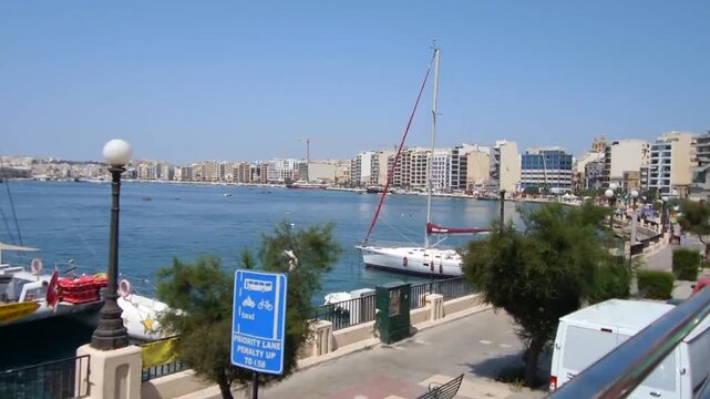 Boats docked in a serene harbor with a cityscape in the background