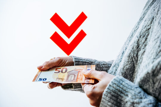 Hands holding euros with contrasting downward arrows.