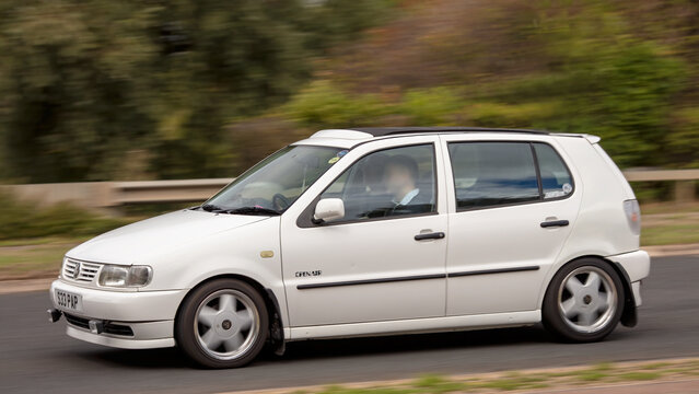 Milton Keynes; UK - Sept. 18th 2026: 1999 white Volkswagen Polo hatchback car driving on a British road