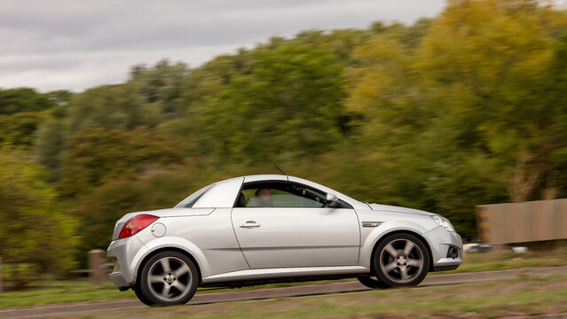 Milton Keynes; UK - Sept. 18th 2026: 2009 silver Vauxhall Tigra car driving on a British road