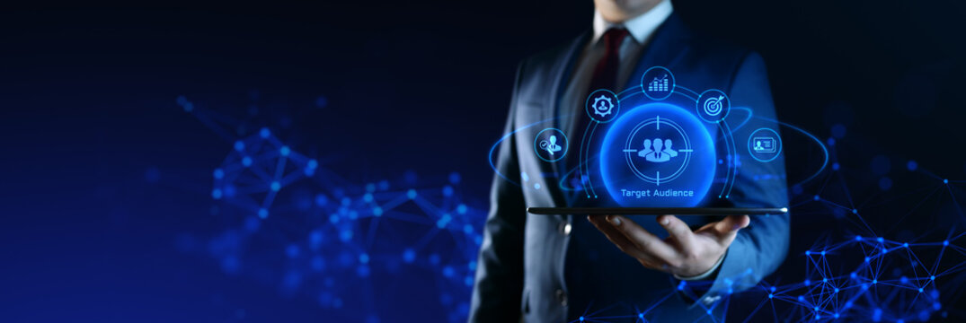 Businessman Holding tablet with Target Audience Icons on Screen. Digital Marketing and business concept
