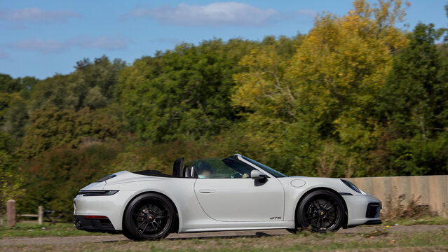 Milton Keynes; UK - Sept. 20th 2026: 3031 white Porsche 911 Carrera GTS  car driving on a British road