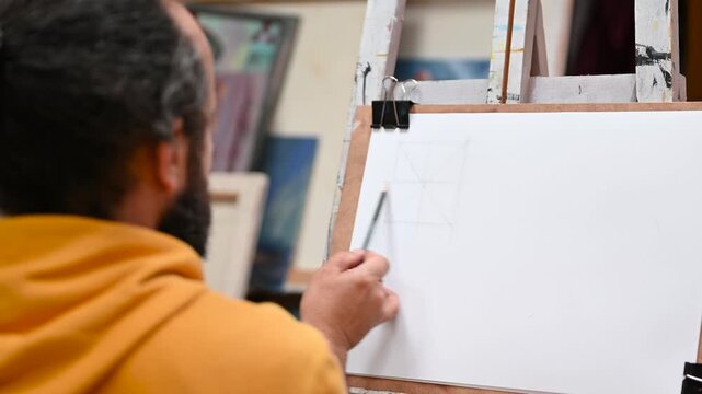 Talented artist doing a quick sketch on paper, pencil in hand, creative studio atmosphere, drawing and art concept