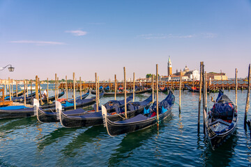 Venetian gondolas with San Giorgio Maggiore across the Venice Lagoon, Italy © Bernadett