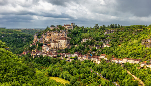Panoramic view over Rocamadour, showing the historic sanctuary and basilica built into the cliffside, with the ch&acirc;teau and surrounding landscape.