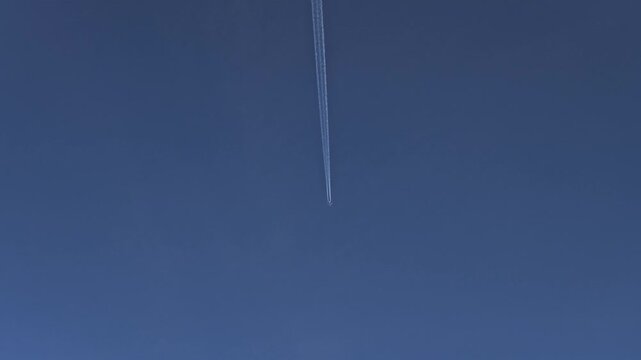 Airplane in the sky no clouds straight trail smoke video 4K
