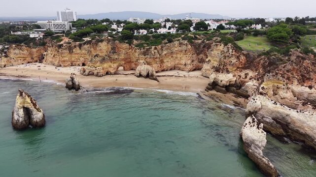 Aerial view of three brothers beach rock formations in alvor, portugal