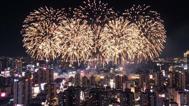 Golden fireworks exploding over a dense city skyline at night