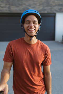 Man smiling while wearing a helmet during outdoor activity