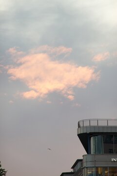 Pink evening clouds above a modern building in Oslo