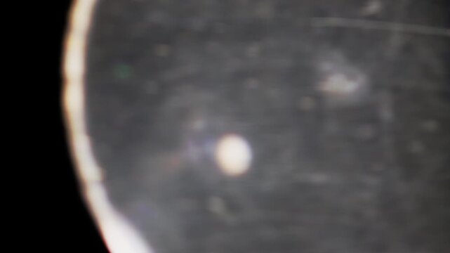 Fast spinning lens glass transition with abstract light reflections