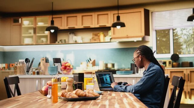 Video game developer tests lobby experience and programs mechanics with animation and visual effects for entertainment industry, showing everyday life of woman digital nomad working at home on laptop.