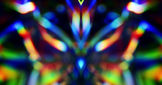 Symmetrical light reflecting glass in brilliant saturated colors. Radiant lighting through a prism cube creating a mirrored colorful rainbow effect of light refraction. Geometric abstract background.