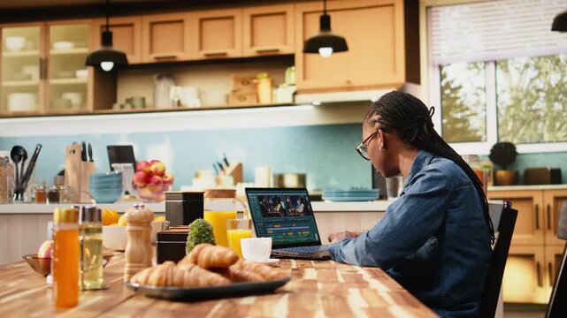 Content creator edits video montage on laptop with color grading, videography and post production techniques, using color correction and VFX tools throughout a creative process while working at home.