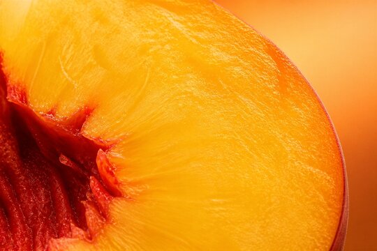 Peach half revealing juicy flesh in macro fruit studio closeup