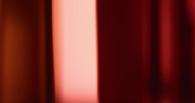 Soft lights illuminate the brilliance of reflective glass creating a moving gradient of smooth amber colors. Swirl of dreamy lighting creating a warm aura for an abstract background or wallpaper Loop