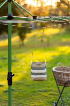 Australian backyard scene of washing line with peg bag and washing basket at sunset