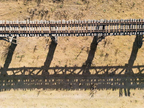 Birds eye view of a wooden disused railway bridge crossing floodplains in Gundagai