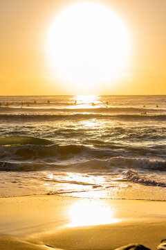 sunset surfers sesh during golden hour at the beach