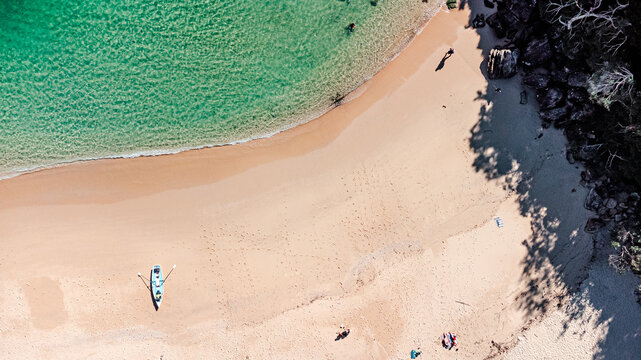 Aerial View of Secluded Beach Cove with Clear Turquoise Water and kayak