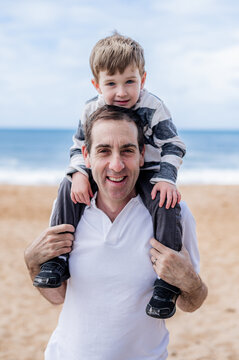 Happy father with his son enjoying a fun day at the beach, creating joyful memories together