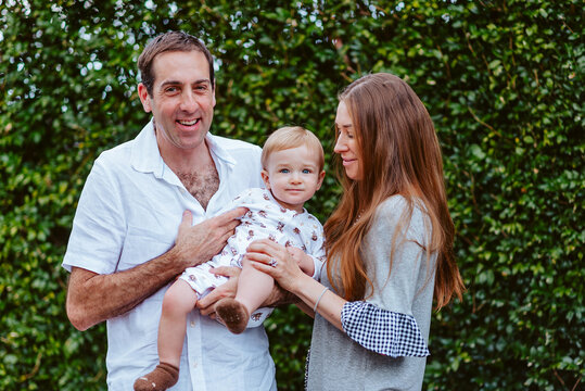 Outdoor family moments with a young boy and his parents on a green background